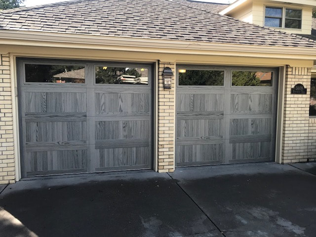 Maintaining Normalcy and Security with Garage Door Services - Carriage Style with Driftwood Finish