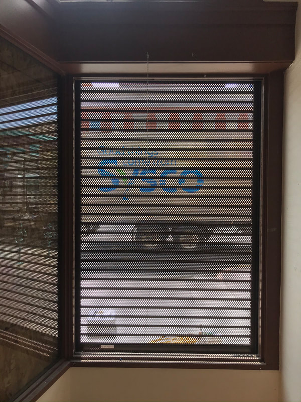 Commercial door with rolling security shutters down.