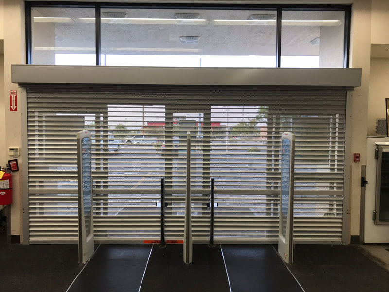 Commercial door with rolling security shutters down.