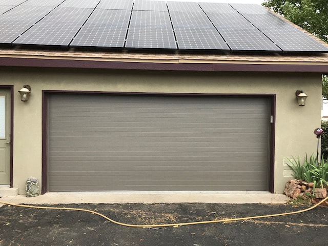 Maintaining Normalcy and Security with Garage Door Services - Plank Style Door with Bronze Finish
